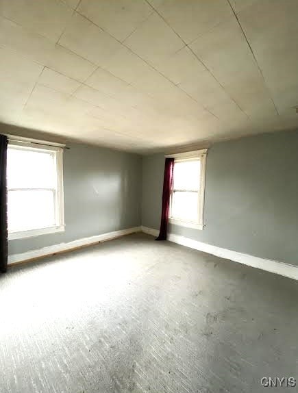 spare room with baseboards