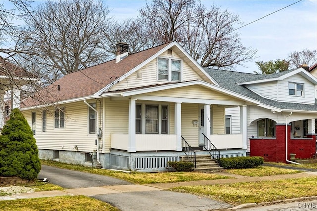1124 Downer Ave, Utica, NY 13502 - bungalow-style home featuring a chimney, a shingled roof, and a porch