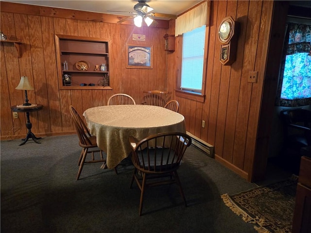 476 Musson Erwin Rd, Butternuts, NY 13843 - carpeted dining area featuring a baseboard radiator, built in features, wood walls, ceiling fan, and baseboards