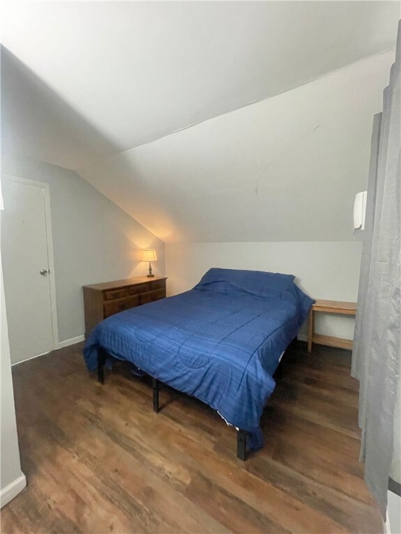 1842 E Lake Rd, Spafford, NY 13152 - bedroom featuring baseboards, vaulted ceiling, and wood finished floors