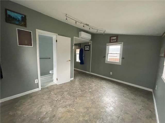 1842 E Lake Rd, Spafford, NY 13152 - unfurnished bedroom with track lighting, a wall unit AC, baseboards, and vaulted ceiling