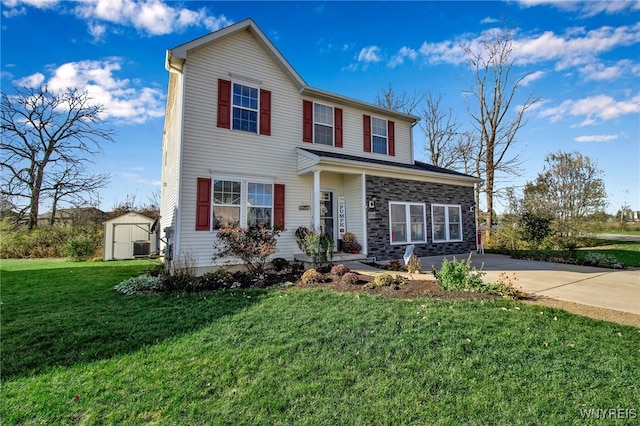 5774 Willow Creek Ln, Cambria, NY 14132 - traditional-style house with a front yard, concrete driveway, central air condition unit, a shed, and an outbuilding