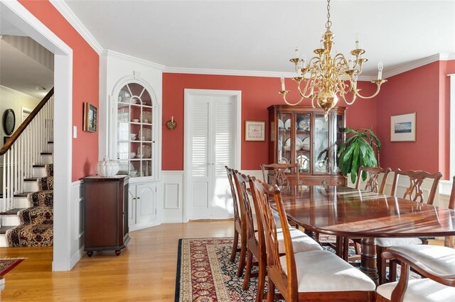 507 Hilltop Rd, Union, NY 13760 - dining space with stairway, a chandelier, wainscoting, light wood-type flooring, and ornamental molding