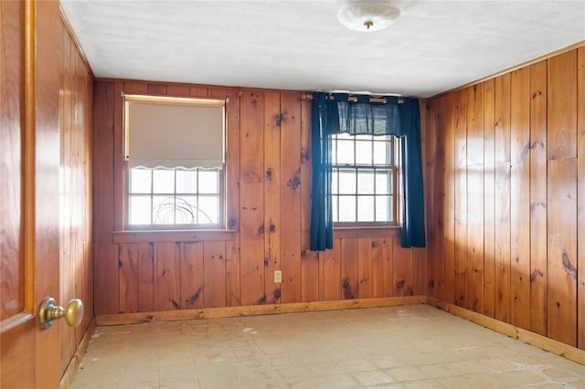 507 Hilltop Rd, Union, NY 13760 - spare room with tile patterned floors, wooden walls, and plenty of natural light