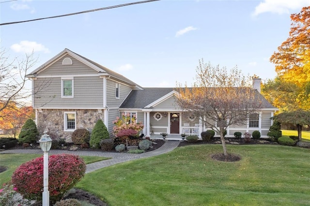 507 Hilltop Rd, Union, NY 13760 - view of front of home featuring stone siding, a chimney, covered porch, and a front yard