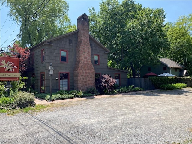 4508 State Route 64, Bristol, NY 14424 - view of side of home with a chimney and fence