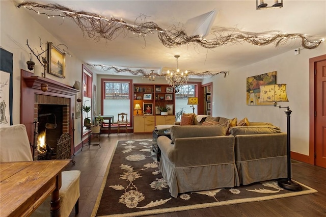 4508 State Route 64, Bristol, NY 14424 - living area with a brick fireplace, dark wood-style flooring, baseboards, and an inviting chandelier