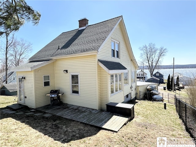 3514 Lake St, Ellicott, NY 14701 - back of house featuring a chimney, a wooden deck, fence, and roof with shingles
