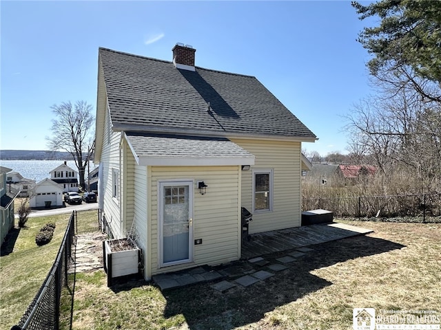 3514 Lake St, Ellicott, NY 14701 - rear view of house with a yard, a chimney, fence, and roof with shingles