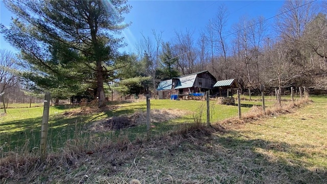view of yard with a barn and an outbuilding