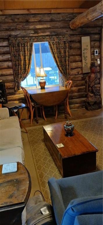 sitting room with log walls and wood finished floors