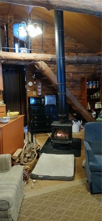 living room with a wood stove and vaulted ceiling