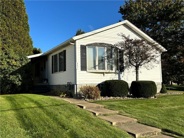 view of property exterior with a lawn
