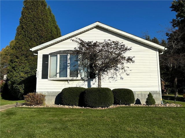 view of side of home featuring a lawn