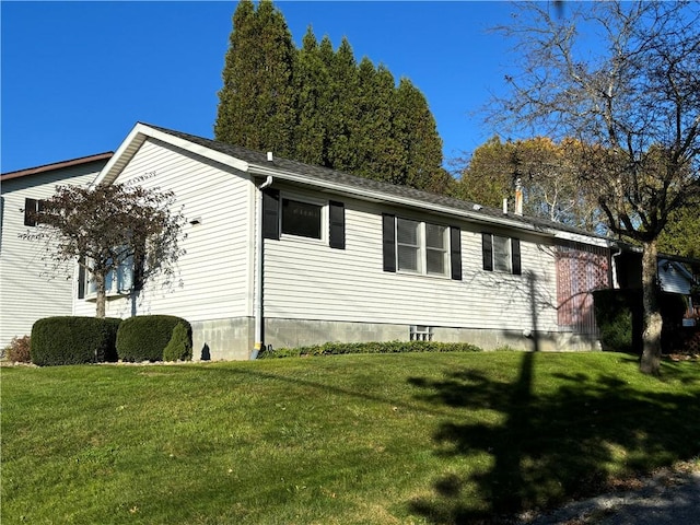view of side of home with a yard