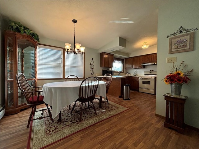 dining space featuring dark wood-style floors, vaulted ceiling, baseboards, and an inviting chandelier