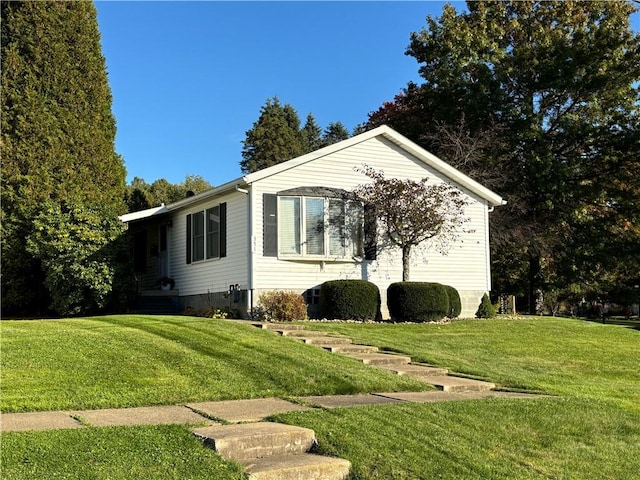 view of side of home with a lawn