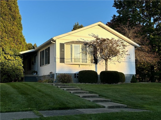 view of side of home with a lawn