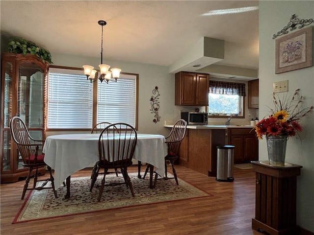 dining area featuring an inviting chandelier and wood finished floors
