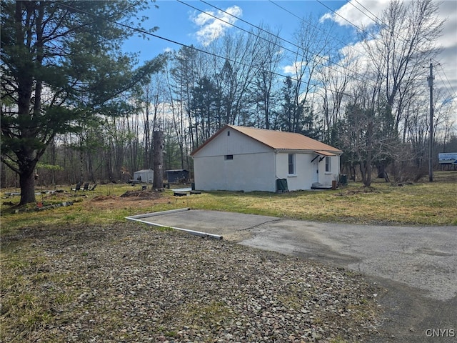 view of property exterior featuring stucco siding and a yard