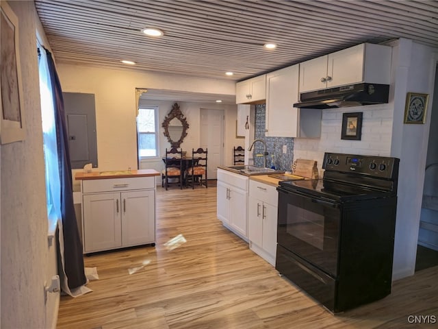kitchen featuring black / electric stove, under cabinet range hood, white cabinets, and a sink