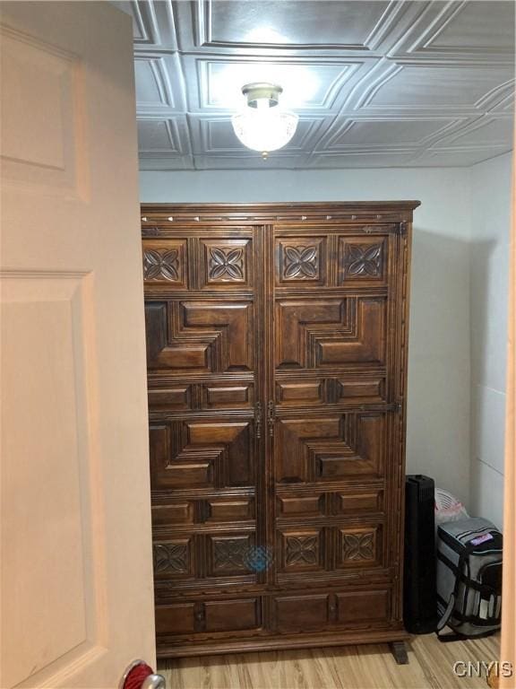 interior details featuring wood finished floors and an ornate ceiling