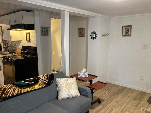 living area with baseboards and light wood finished floors
