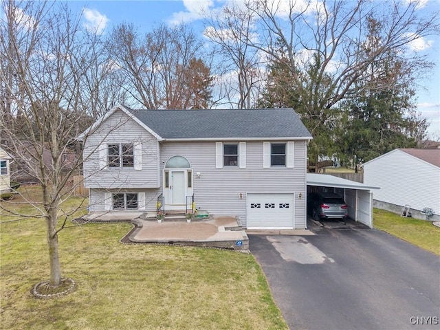 raised ranch with driveway, a front yard, roof with shingles, an attached carport, and an attached garage