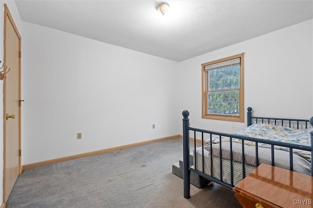 bedroom featuring baseboards and light colored carpet