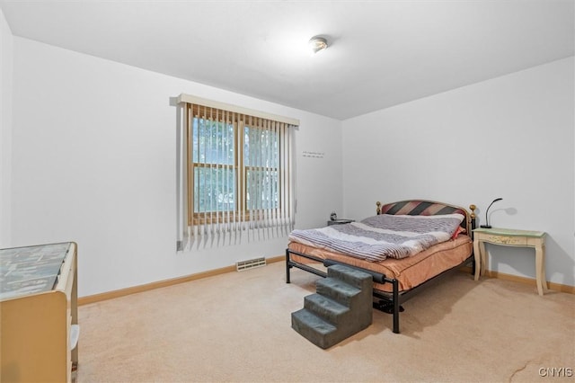carpeted bedroom featuring baseboards and visible vents