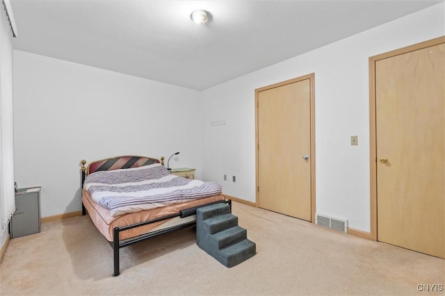 bedroom with light carpet, baseboards, and visible vents