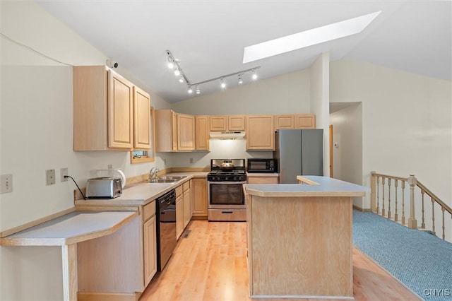 kitchen featuring a center island, black appliances, light countertops, and light brown cabinetry