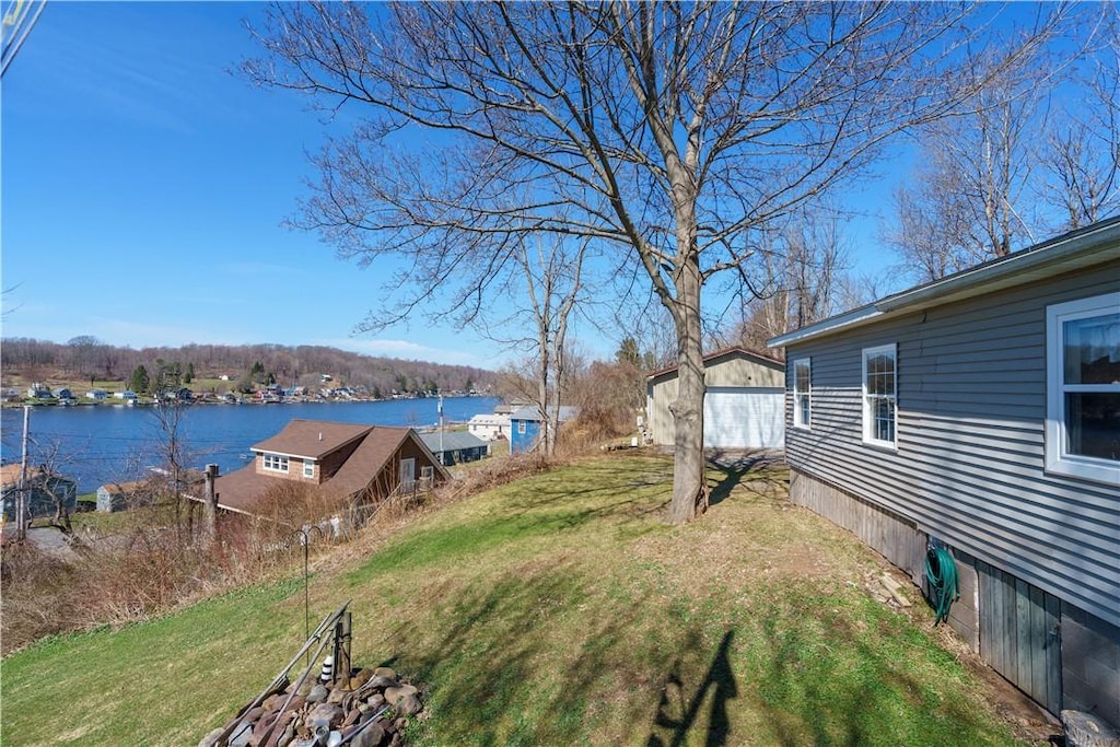 7804 Eagle Rd, Wolcott, NY 14590 - view of yard with a garage and a water view