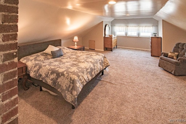 carpeted bedroom with lofted ceiling