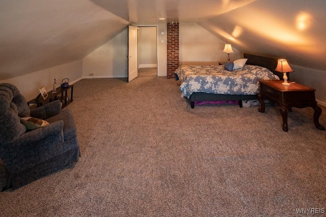 bedroom with carpet floors and lofted ceiling
