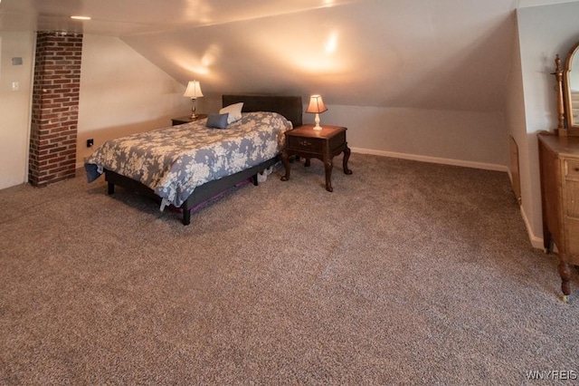 carpeted bedroom featuring lofted ceiling and baseboards