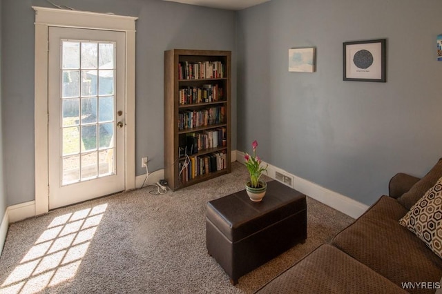 living area with baseboards, carpet flooring, and visible vents