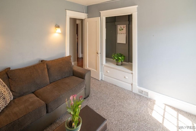 living room featuring visible vents and carpet