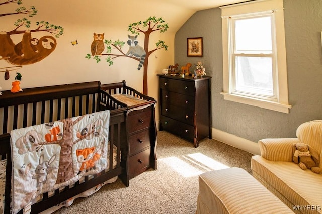 carpeted bedroom with lofted ceiling