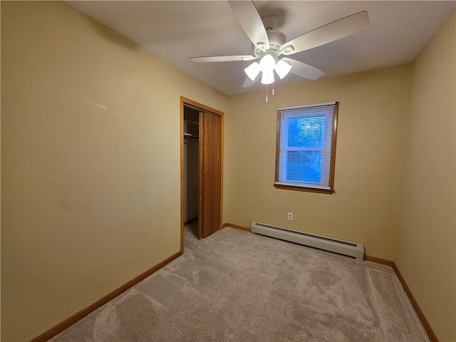 unfurnished bedroom with light colored carpet, a baseboard radiator, and baseboards