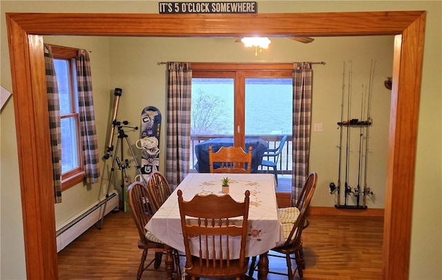 dining room with a baseboard radiator and wood finished floors