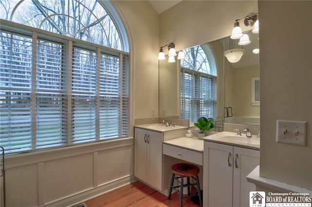 2401/2 Lakeside Dr, Ellery, NY 14712 - bathroom with a sink, two vanities, and wood finished floors