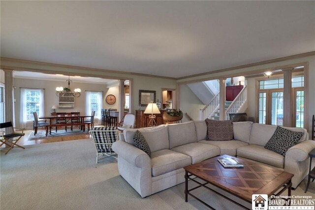 2401/2 Lakeside Dr, Ellery, NY 14712 - living room with crown molding, ornate columns, a chandelier, and stairs