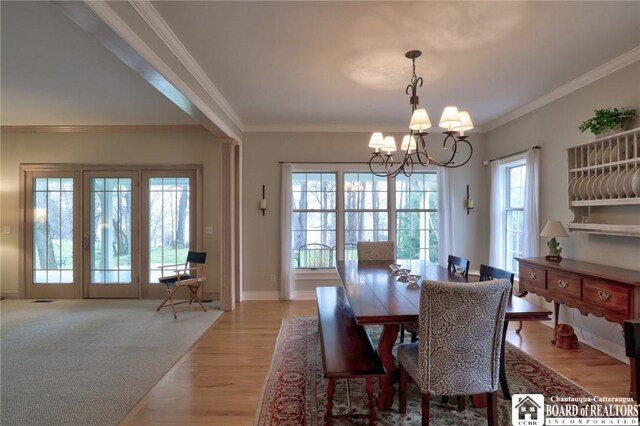 2401/2 Lakeside Dr, Ellery, NY 14712 - dining area with crown molding, light wood-style flooring, a chandelier, and baseboards