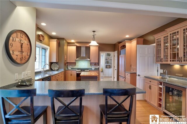 2401/2 Lakeside Dr, Ellery, NY 14712 - kitchen with gas stove, a peninsula, wall chimney exhaust hood, wine cooler, and a sink
