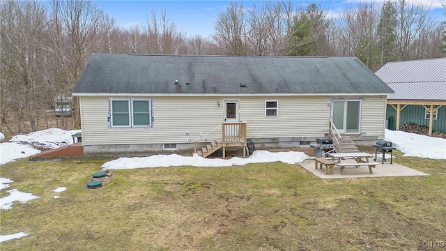 rear view of house featuring entry steps, a yard, and a patio area