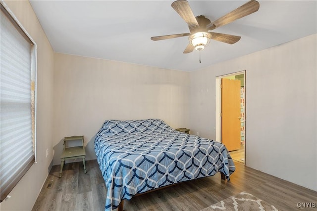 bedroom featuring a ceiling fan and wood finished floors