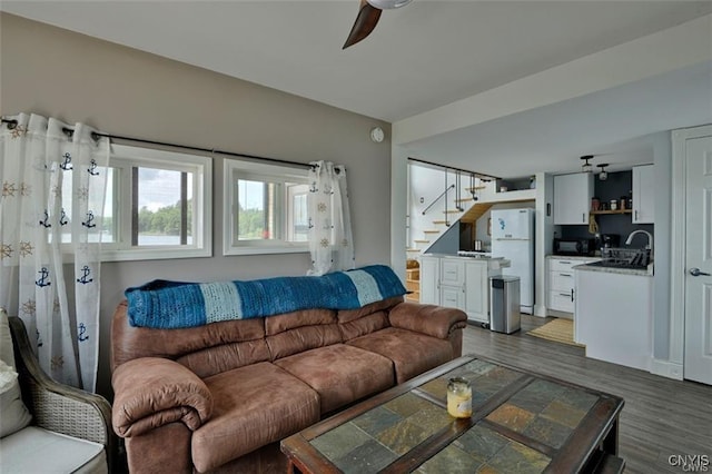 46337 Lake Of The Isle, Alexandria, NY 13607 - living room featuring a ceiling fan, stairs, and wood finished floors