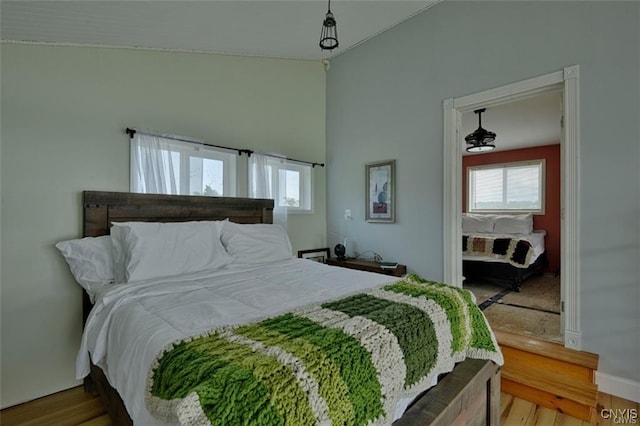 46337 Lake Of The Isle, Alexandria, NY 13607 - bedroom with multiple windows, vaulted ceiling, and wood finished floors