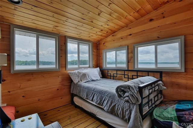 46337 Lake Of The Isle, Alexandria, NY 13607 - bedroom featuring vaulted ceiling, wood finished floors, wooden ceiling, and wood walls